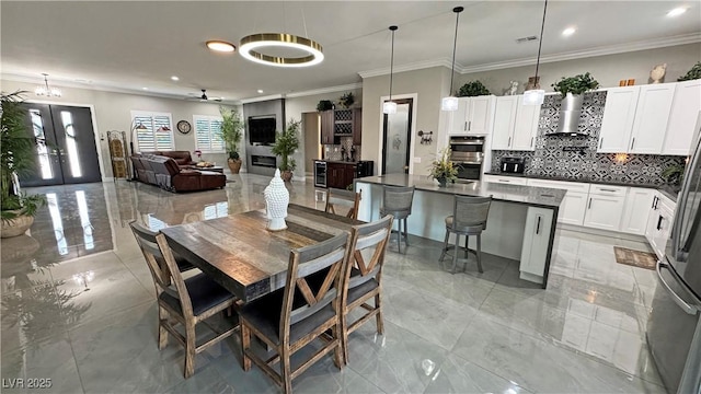 2891 S Rainbow Ave, Pahrump, NV 89048 - dining area with ornamental molding, recessed lighting, beverage cooler, and light marble finish floors