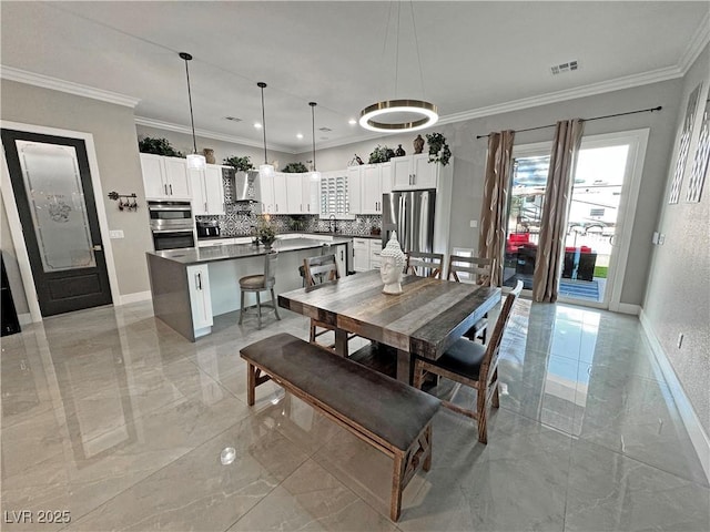 2891 S Rainbow Ave, Pahrump, NV 89048 - dining area with light marble finish floors and ornamental molding