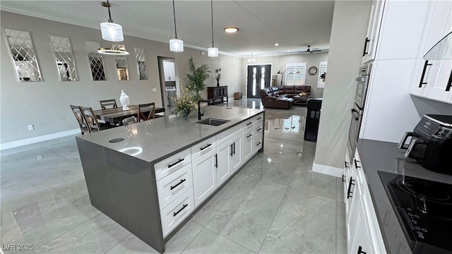 2891 S Rainbow Ave, Pahrump, NV 89048 - kitchen featuring ornamental molding, black electric cooktop, light marble finish flooring, open floor plan, and recessed lighting