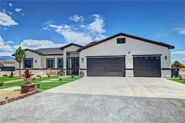 2891 S Rainbow Ave, Pahrump, NV 89048 - ranch-style home featuring driveway, stucco siding, an attached garage, and a front lawn
