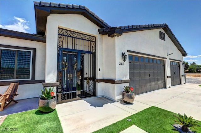 2891 S Rainbow Ave, Pahrump, NV 89048 - view of exterior entry with driveway and a garage