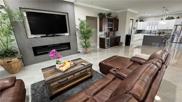2891 S Rainbow Ave, Pahrump, NV 89048 - living room with a glass covered fireplace, beverage cooler, recessed lighting, crown molding, and light marble finish flooring
