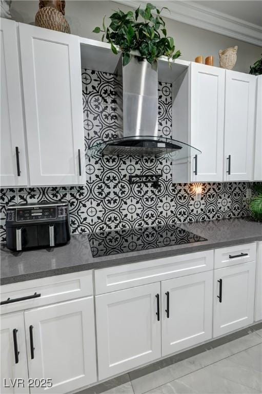 2891 S Rainbow Ave, Pahrump, NV 89048 - kitchen with black stovetop, crown molding, wall chimney range hood, dark countertops, and decorative backsplash