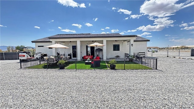 2891 S Rainbow Ave, Pahrump, NV 89048 - rear view of property featuring ceiling fan, a patio, and stucco siding