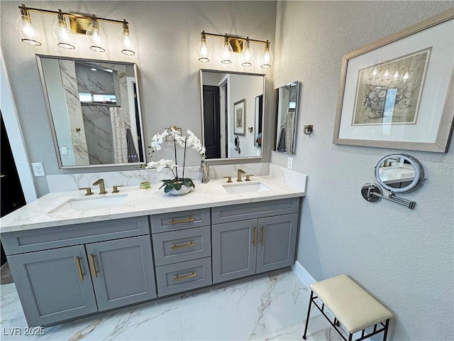2891 S Rainbow Ave, Pahrump, NV 89048 - full bathroom featuring marble look tiles, a textured wall, double vanity, and a marble finish shower