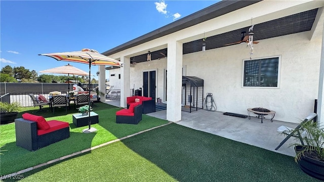 2891 S Rainbow Ave, Pahrump, NV 89048 - view of patio / terrace featuring an outdoor living space with a fire pit