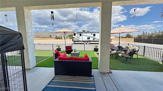 2891 S Rainbow Ave, Pahrump, NV 89048 - fenced backyard featuring a patio area and an outdoor hangout area