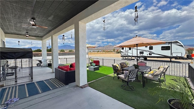 2891 S Rainbow Ave, Pahrump, NV 89048 - view of patio / terrace featuring outdoor dining space, an outdoor living space, and a ceiling fan