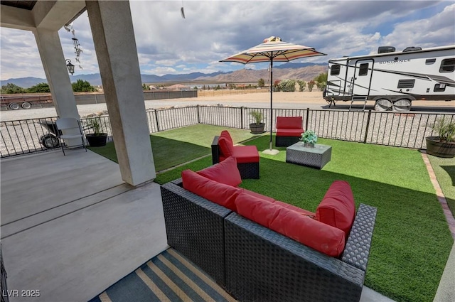 2891 S Rainbow Ave, Pahrump, NV 89048 - fenced backyard featuring a mountain view, outdoor lounge area, and a patio