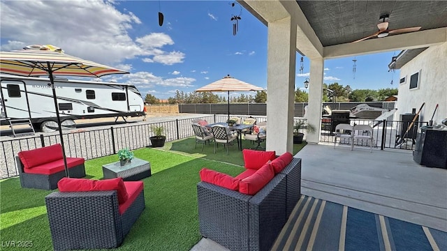 2891 S Rainbow Ave, Pahrump, NV 89048 - fenced backyard with outdoor dining area, ceiling fan, and an outdoor hangout area