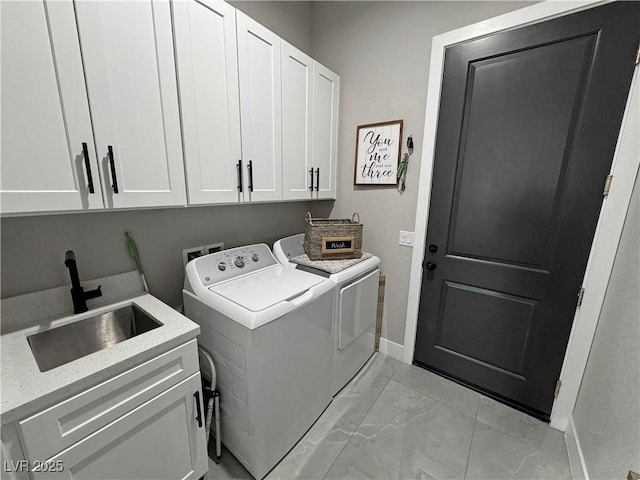 2891 S Rainbow Ave, Pahrump, NV 89048 - laundry room with cabinet space, washing machine and clothes dryer, and light marble finish flooring