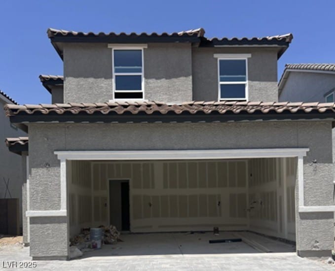 7341 Daly Grove St, Las Vegas, NV 89113 - view of front of property featuring a tiled roof, stucco siding, a garage, and driveway