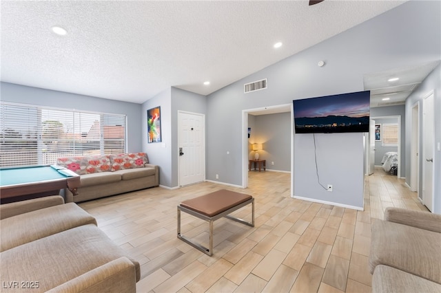 1012 Greystone Dr, Las Vegas, NV 89108 - living room with vaulted ceiling, a textured ceiling, recessed lighting, and light wood-style floors