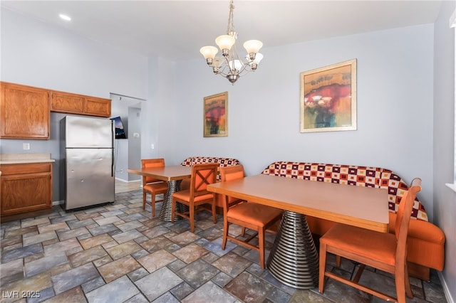 1012 Greystone Dr, Las Vegas, NV 89108 - dining area featuring a chandelier and stone finish floors