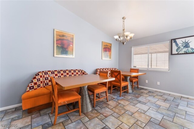 1012 Greystone Dr, Las Vegas, NV 89108 - dining space with a chandelier, vaulted ceiling, and stone finish flooring