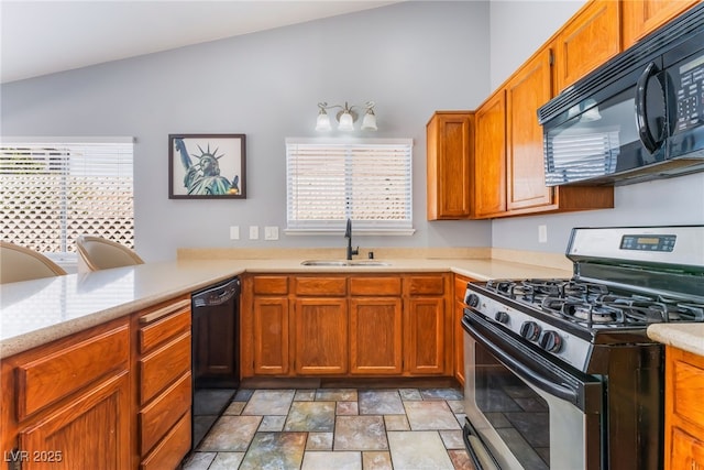 1012 Greystone Dr, Las Vegas, NV 89108 - kitchen with black appliances, healthy amount of natural light, stone finish floors, and light countertops
