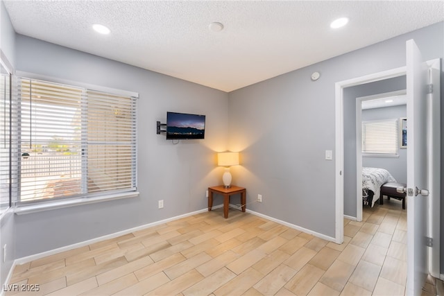 1012 Greystone Dr, Las Vegas, NV 89108 - unfurnished room with a textured ceiling, recessed lighting, and light wood-style flooring