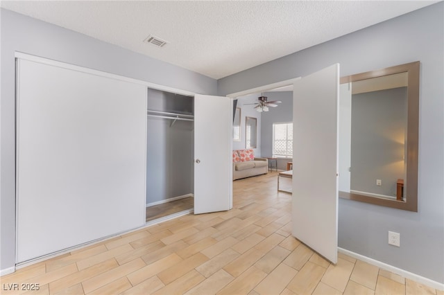 1012 Greystone Dr, Las Vegas, NV 89108 - unfurnished bedroom featuring a textured ceiling, a closet, and light wood-style floors