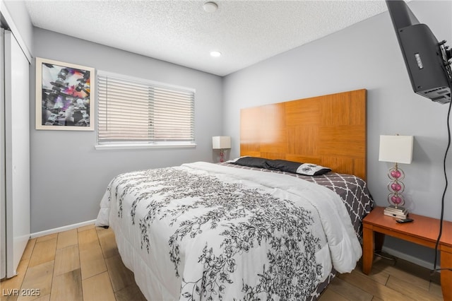 1012 Greystone Dr, Las Vegas, NV 89108 - bedroom featuring light wood-style floors, a textured ceiling, and recessed lighting
