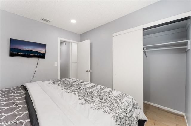 1012 Greystone Dr, Las Vegas, NV 89108 - bedroom featuring recessed lighting, a closet, light wood-type flooring, and a textured ceiling