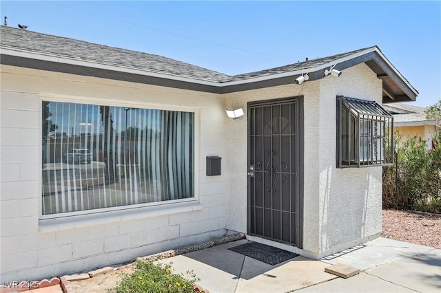 882 Westminster Ave, Las Vegas, NV 89119 - doorway to property featuring concrete block siding and roof with shingles