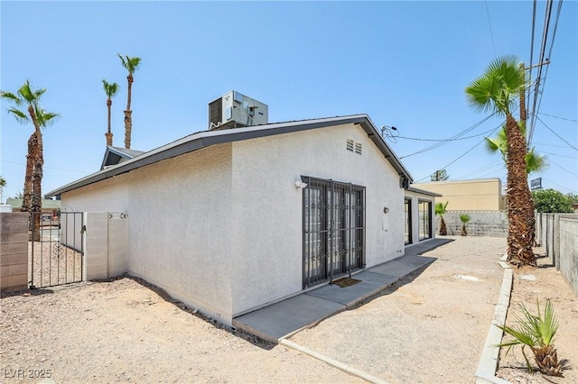 882 Westminster Ave, Las Vegas, NV 89119 - view of home's exterior featuring a fenced backyard, a gate, stucco siding, and a patio area