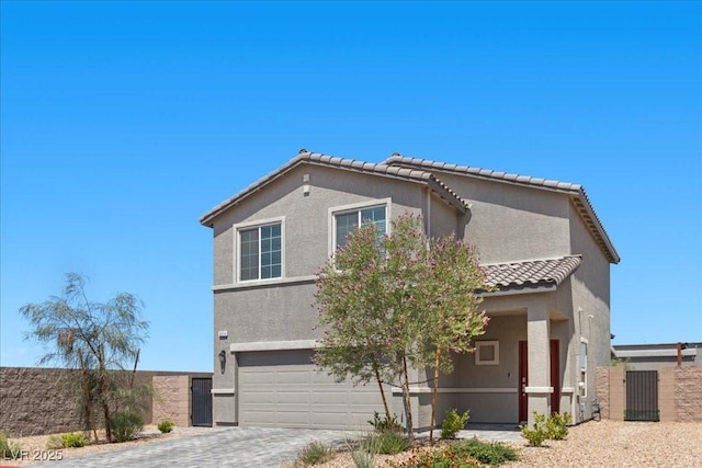 9054 Tangerine Tree Ct, Las Vegas, NV 89113 - view of front of home featuring an attached garage, a tiled roof, stucco siding, and driveway