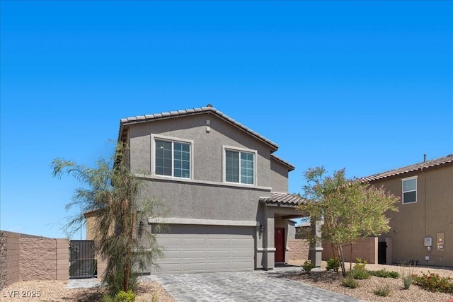 9054 Tangerine Tree Ct, Las Vegas, NV 89113 - view of front of home featuring stucco siding, a garage, decorative driveway, a tiled roof, and a gate
