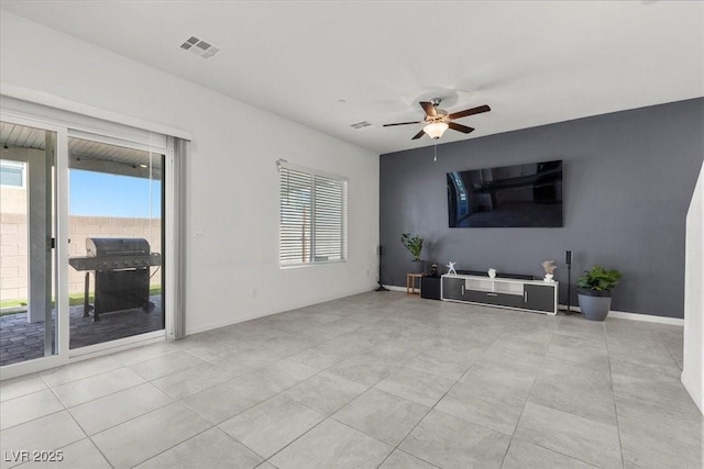 9054 Tangerine Tree Ct, Las Vegas, NV 89113 - unfurnished living room featuring healthy amount of natural light, ceiling fan, and light tile patterned floors