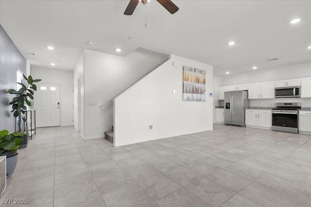9054 Tangerine Tree Ct, Las Vegas, NV 89113 - unfurnished living room with recessed lighting, stairway, a ceiling fan, and light tile patterned floors
