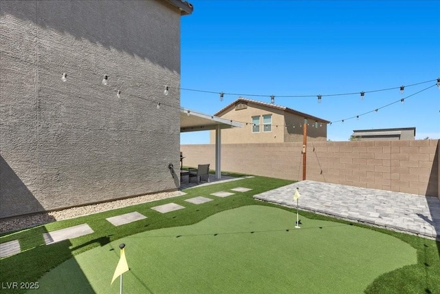 9054 Tangerine Tree Ct, Las Vegas, NV 89113 - view of yard featuring a putting green and a patio