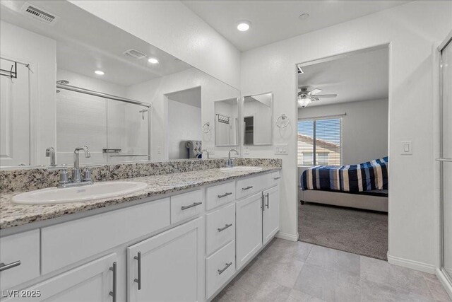 9054 Tangerine Tree Ct, Las Vegas, NV 89113 - ensuite bathroom featuring a ceiling fan, double vanity, and a shower stall