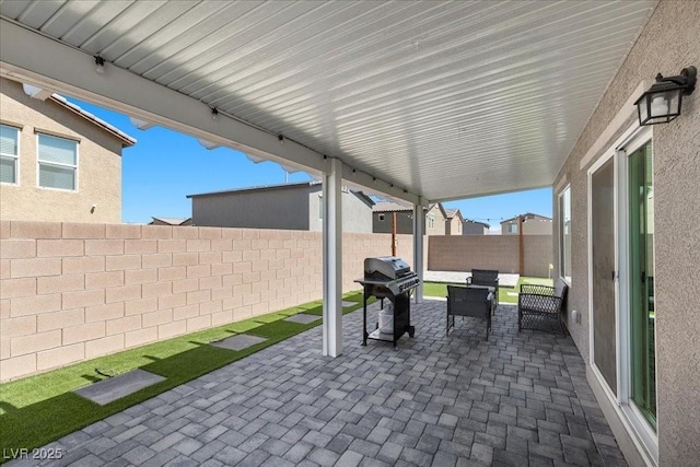 9054 Tangerine Tree Ct, Las Vegas, NV 89113 - fenced backyard with grilling area, a patio, and outdoor lounge area