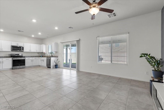 9054 Tangerine Tree Ct, Las Vegas, NV 89113 - kitchen featuring stainless steel appliances, recessed lighting, ceiling fan, white cabinets, and light tile patterned floors