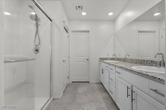 9054 Tangerine Tree Ct, Las Vegas, NV 89113 - bathroom featuring a shower stall and double vanity