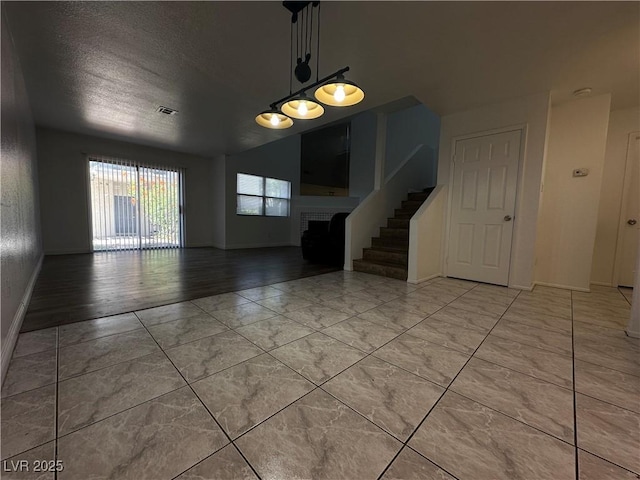 6250 W Flamingo Rd Unit 88, Las Vegas, NV 89103 - unfurnished room with a brick fireplace, a textured ceiling, and stairs