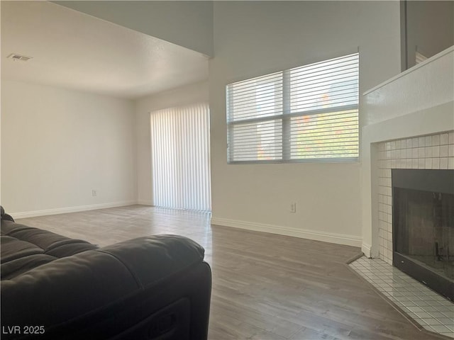 6250 W Flamingo Rd Unit 88, Las Vegas, NV 89103 - living area featuring wood finished floors and a tiled fireplace