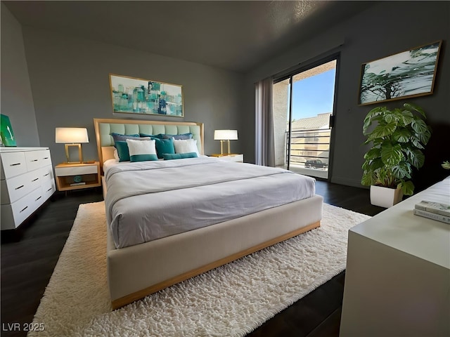 6250 W Flamingo Rd Unit 88, Las Vegas, NV 89103 - bedroom with access to outside and dark wood-style flooring
