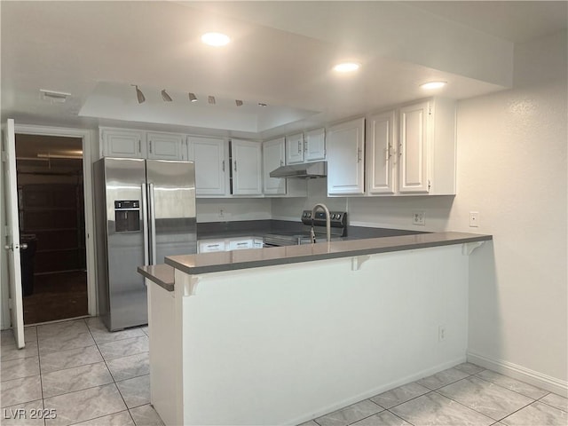 6250 W Flamingo Rd Unit 88, Las Vegas, NV 89103 - kitchen featuring stainless steel refrigerator with ice dispenser, range with electric cooktop, a peninsula, under cabinet range hood, and dark countertops
