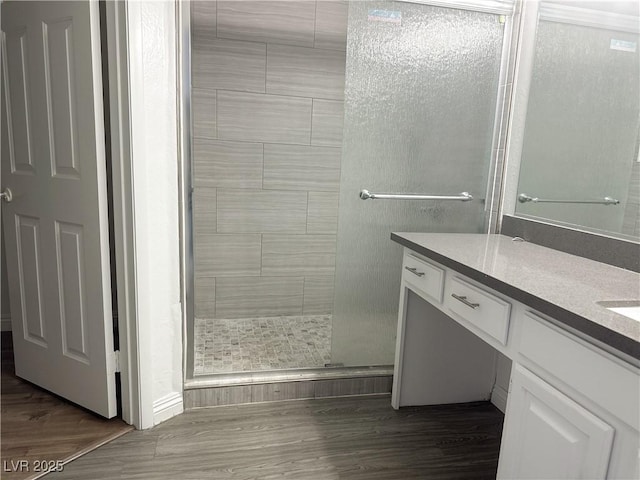 6250 W Flamingo Rd Unit 88, Las Vegas, NV 89103 - bathroom featuring a shower stall, vanity, and wood finished floors
