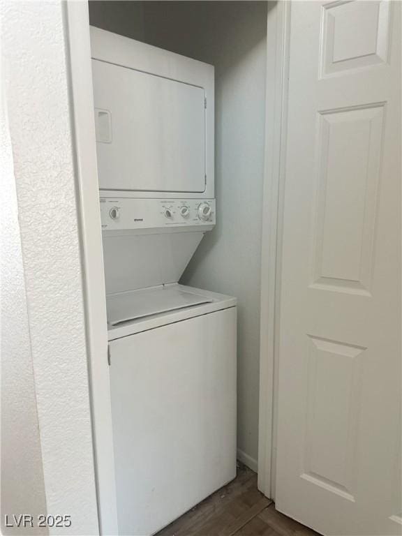 6250 W Flamingo Rd Unit 88, Las Vegas, NV 89103 - laundry room with stacked washer / drying machine and dark wood-style floors
