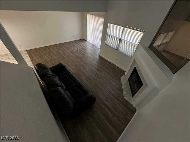 6250 W Flamingo Rd Unit 88, Las Vegas, NV 89103 - unfurnished living room featuring wood finished floors and a fireplace