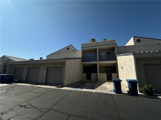 6250 W Flamingo Rd Unit 88, Las Vegas, NV 89103 - view of front of home featuring stucco siding and community garages