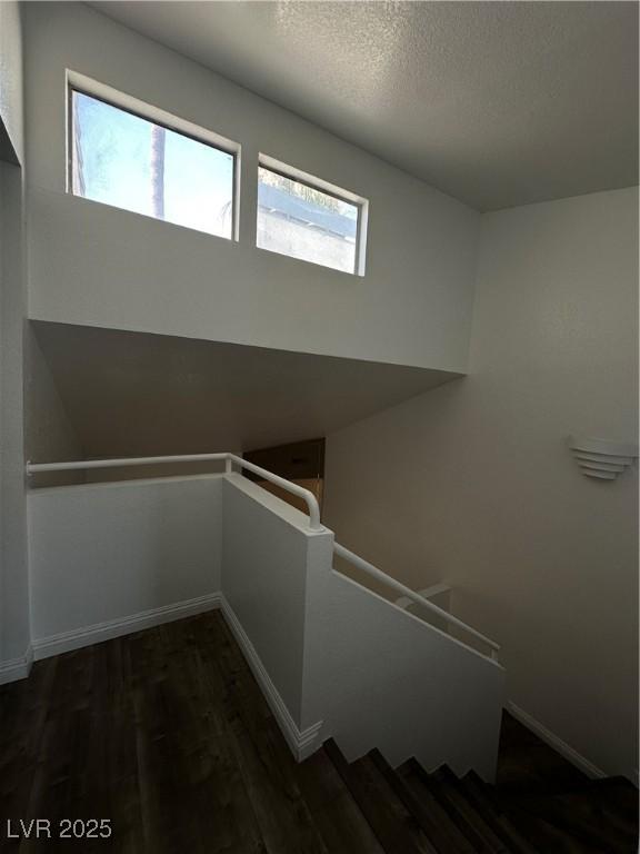 6250 W Flamingo Rd Unit 88, Las Vegas, NV 89103 - staircase featuring wood finished floors and a textured ceiling