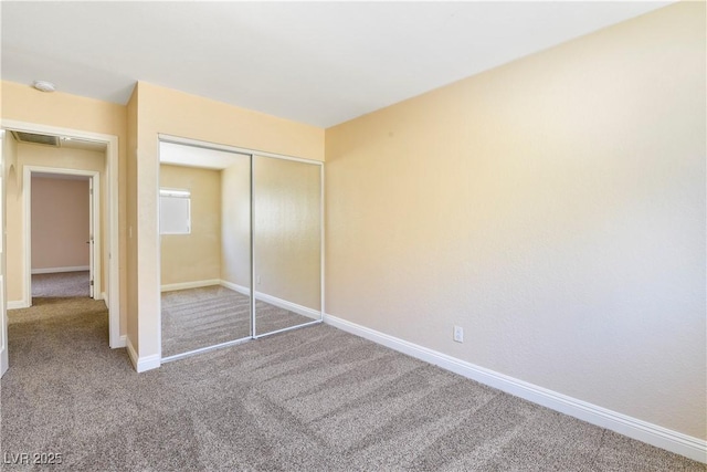 1836 N Decatur Blvd Unit 203, Las Vegas, NV 89108 - unfurnished bedroom featuring carpet flooring and a closet
