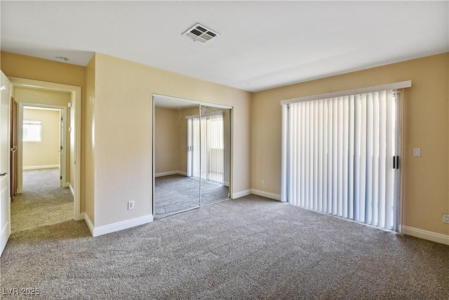 1836 N Decatur Blvd Unit 203, Las Vegas, NV 89108 - unfurnished bedroom featuring multiple windows, carpet, and a closet