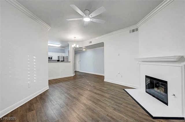 5250 S Rainbow Blvd Unit 1057, Las Vegas, NV 89118 - unfurnished living room featuring ornamental molding, ceiling fan, a glass covered fireplace, dark wood-style flooring, and a chandelier