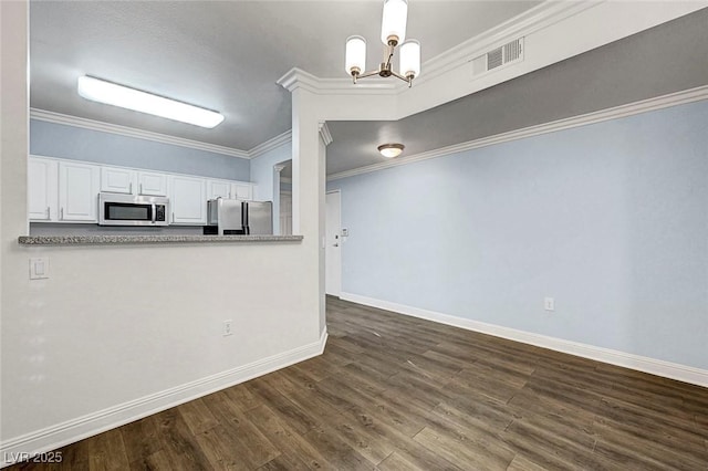 5250 S Rainbow Blvd Unit 1057, Las Vegas, NV 89118 - kitchen with appliances with stainless steel finishes, a chandelier, white cabinetry, ornamental molding, and dark wood-style floors