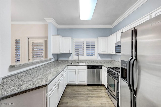 5250 S Rainbow Blvd Unit 1057, Las Vegas, NV 89118 - kitchen featuring stainless steel appliances, white cabinetry, ornamental molding, and light wood finished floors