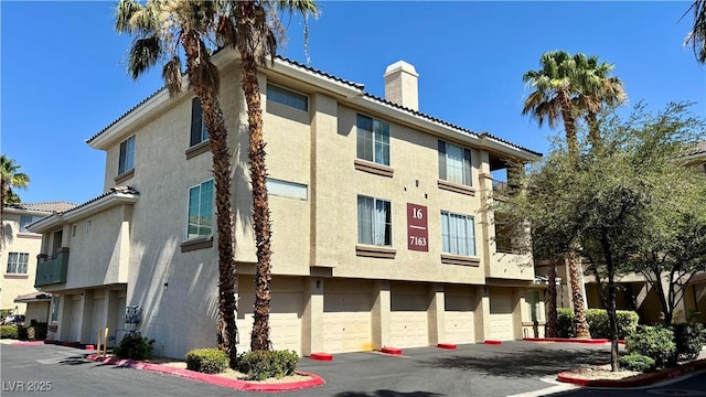 7163 S Durango Dr Unit 113, Las Vegas, NV 89113 - view of building exterior featuring an attached garage and driveway
